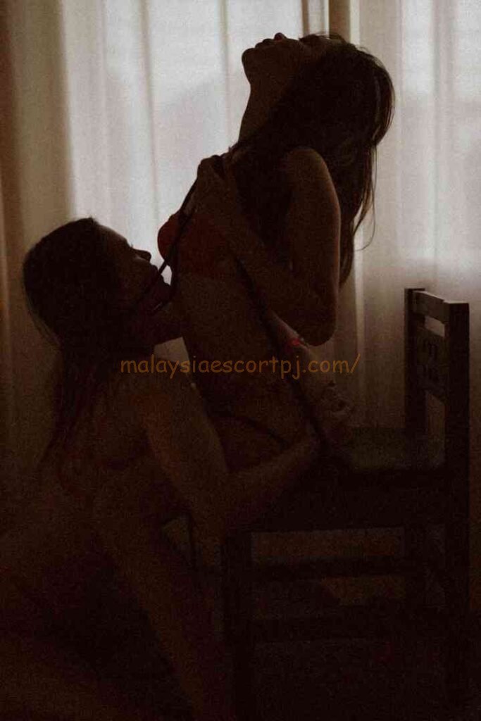 Silhouetted couple in intimate embrace by window