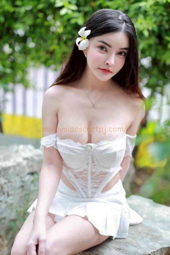 Young woman in white lingerie posing outdoors