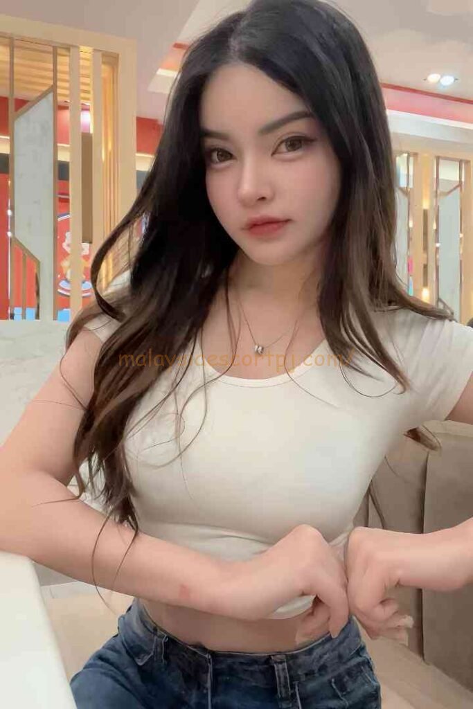 Young woman with long dark hair wearing a white t-shirt and jeans